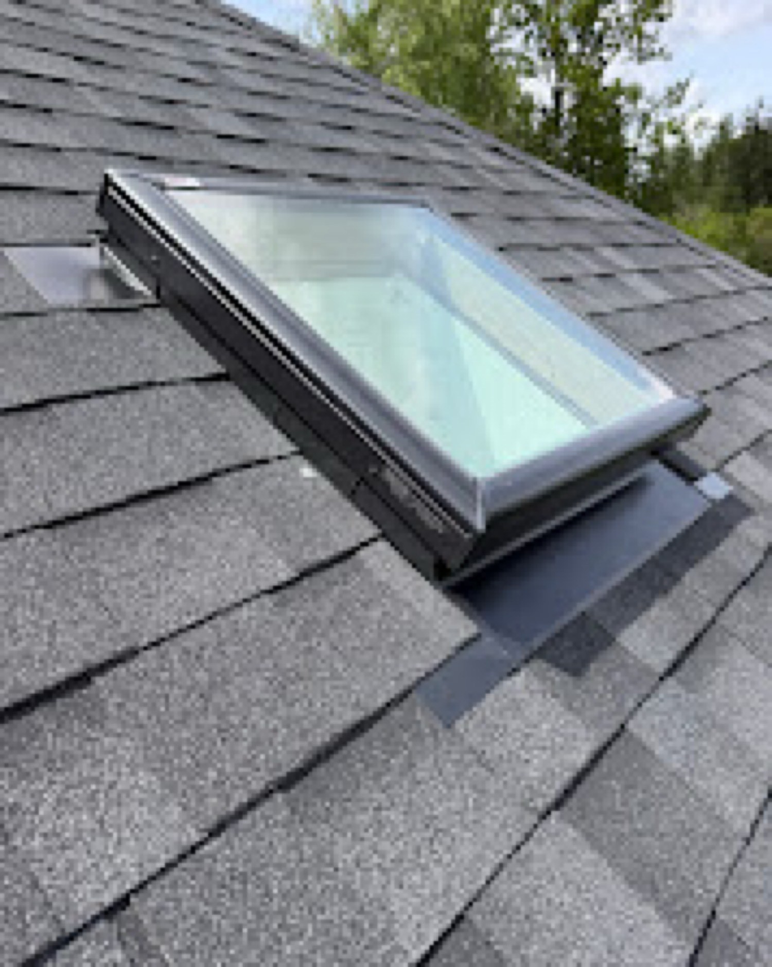 New skylight flashed into an architectural shingle roof