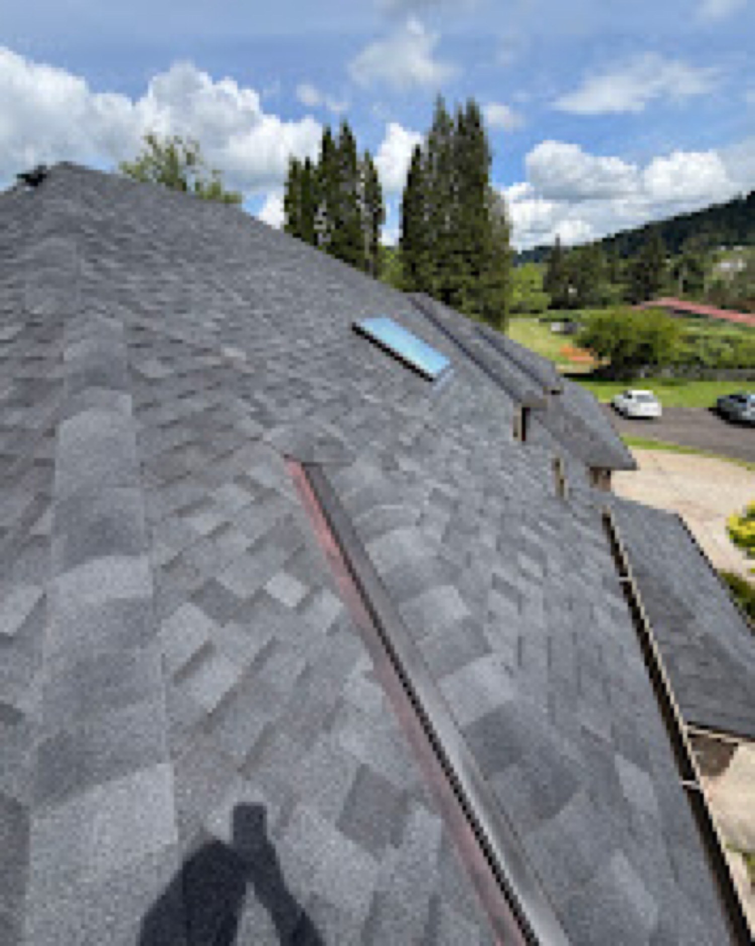 Finished roof slope with skylight and valley metal